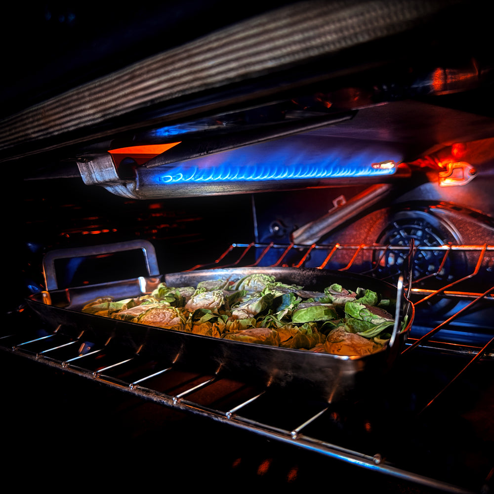 
                  
                    stainless steel drip 'n griddle pan baking veggies in oven
                  
                